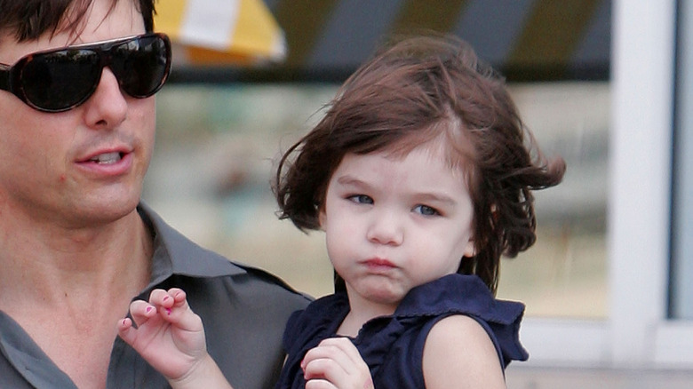 Tom Cruise carrying baby Suri