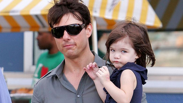 Tom Cruise holding Suri 