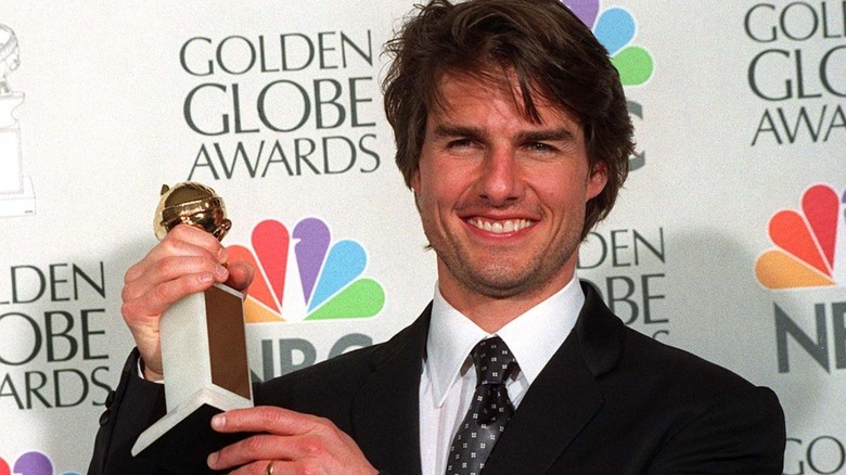 Tom Cruise holding a Golden Globe award