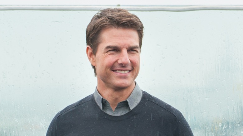 Tom Cruise all smiles in rainy Moscow