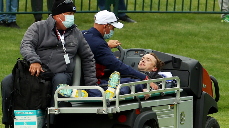 Tom Felton being transported on a stretcher 