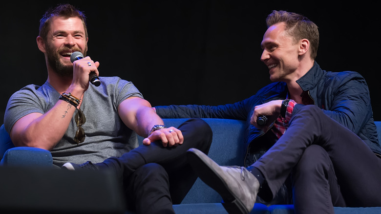 Chris Hemsworth and Tom Hiddleston speaking at an event