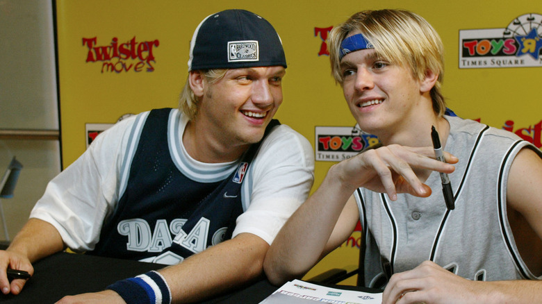 Aaron and Nick Carter signing autographs