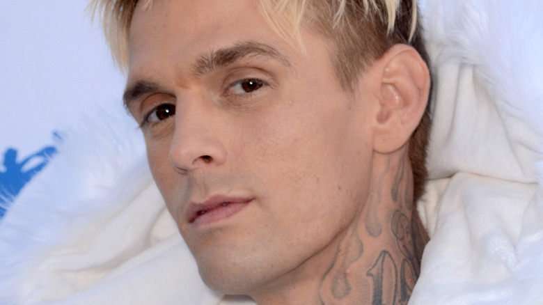 Aaron Carter wearing white coat