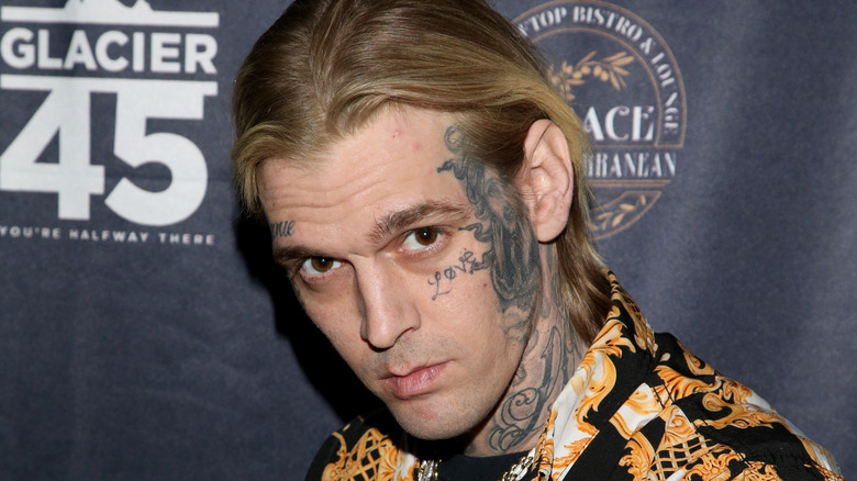 Aaron Carter showing his face tattoo