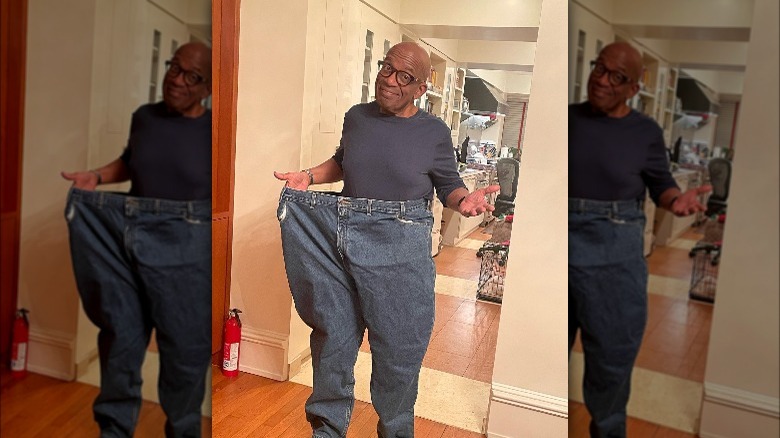 Al Roker holding his old jeans