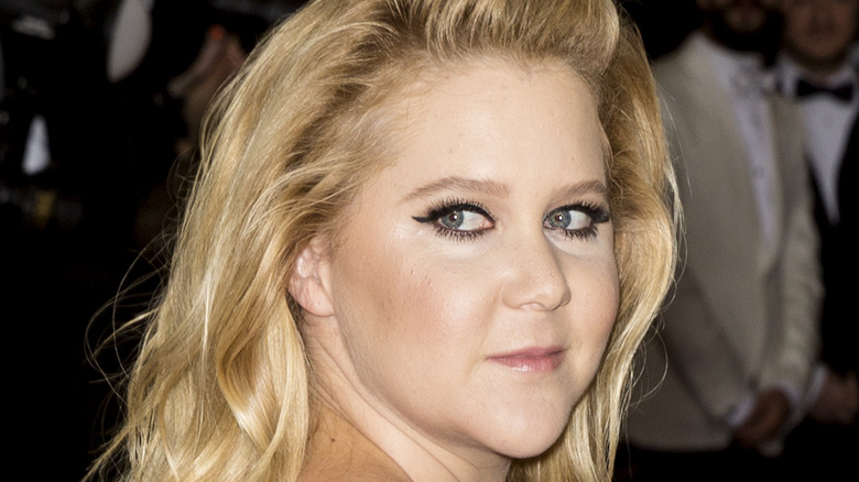 Amy Schumer at an event, looking serious