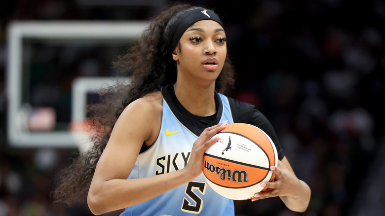 Angel Reese holding a basketball