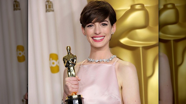 Anne Hathaway, smiling with her Oscars, 2013 photo 