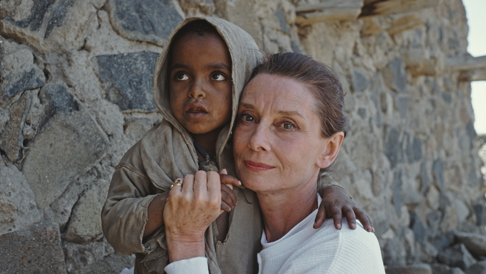 Audrey Hepburn with a child while working for UNICEF