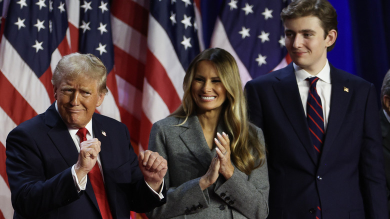 Melania Trump and son Barron smiling at Donald Trump