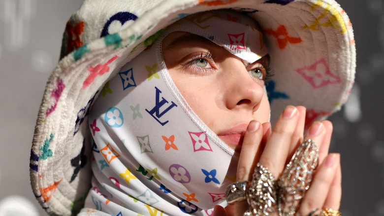 Billie Eilish in Yves Saint Laurent face mask and hat