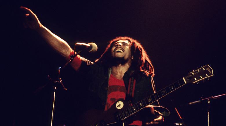 Bob Marley pointing skyward during concert