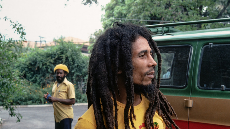 Bob Marley photographed in front of a car