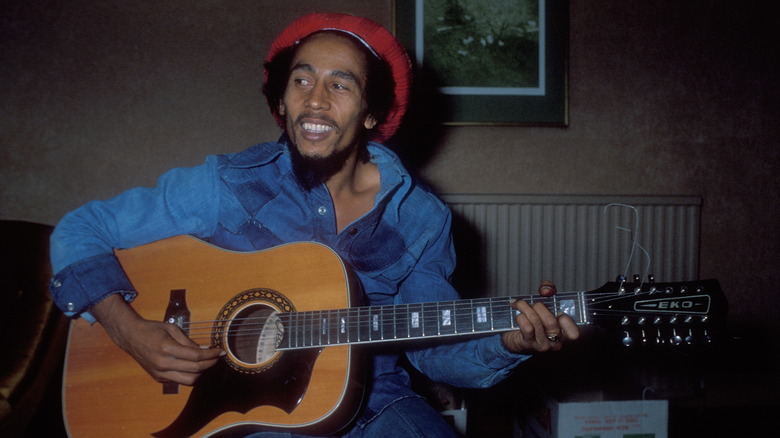 Bob Marley playing guitar in hotel