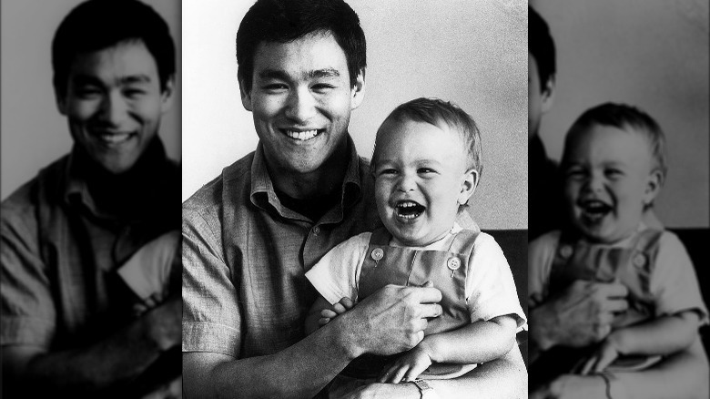 Bruce Lee holding son Brandon smiling