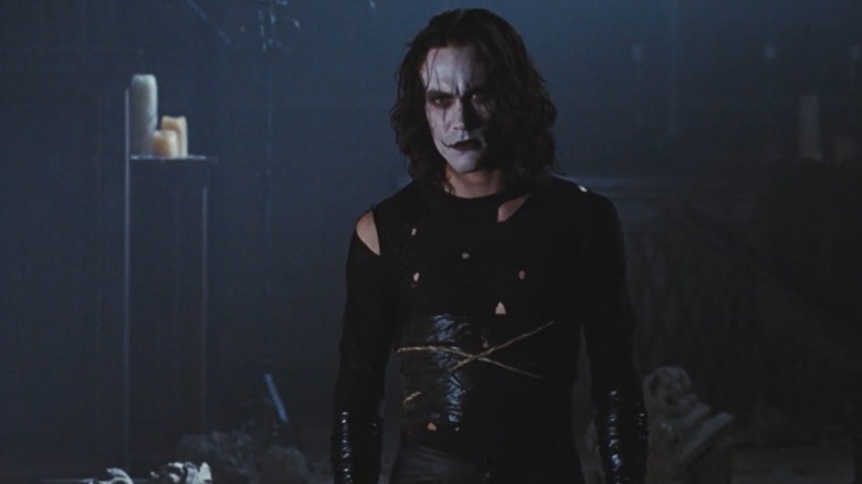 Brandon Lee wearing slashed shirt