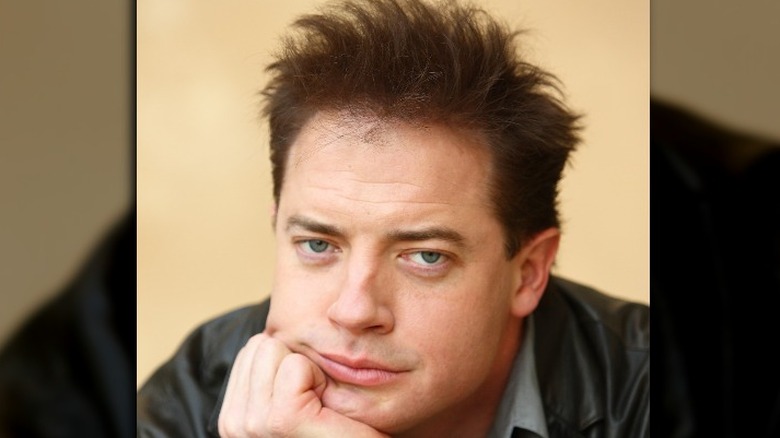 Brendan Fraser with hand on chin