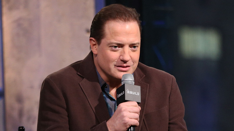 Brendan Fraser talking into microphone