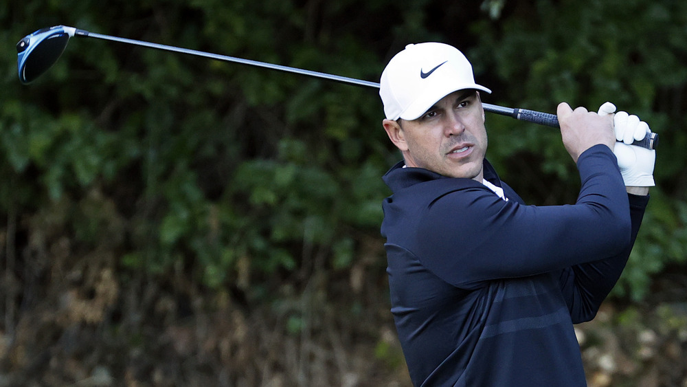 Brooks Koepka takes his shot on course