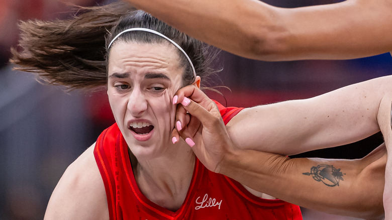 Caitlin Clark driving basketball 