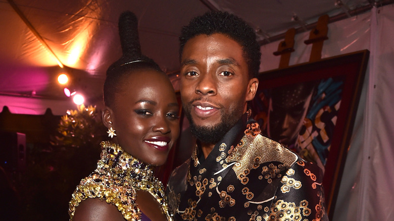 Lupita Nyong'o and Chadwick Boseman smiling