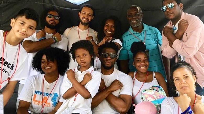 Chadwick Boseman Wakanda salute with children and volunteers