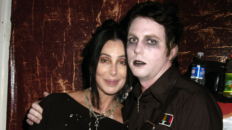 Cher and Elijah Blue Allman posing together, with Elijah in full makeup.