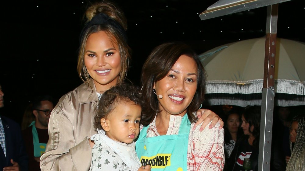 Chrissy Teigen smiling with mom Vilailuck "Pepper" Teigen and son Miles