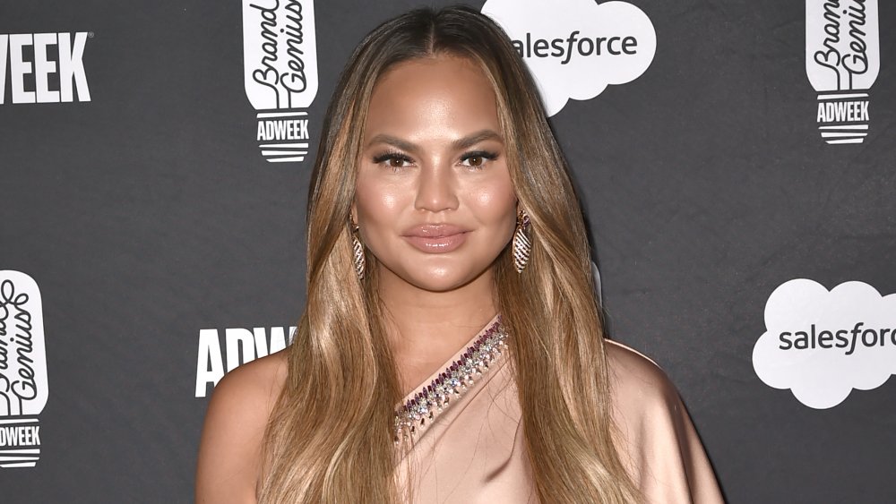 Chrissy Teigen posing with a small smile 