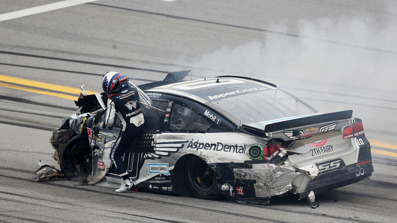 Danica Patrick gets out of her smoking car on the track in Talladega.