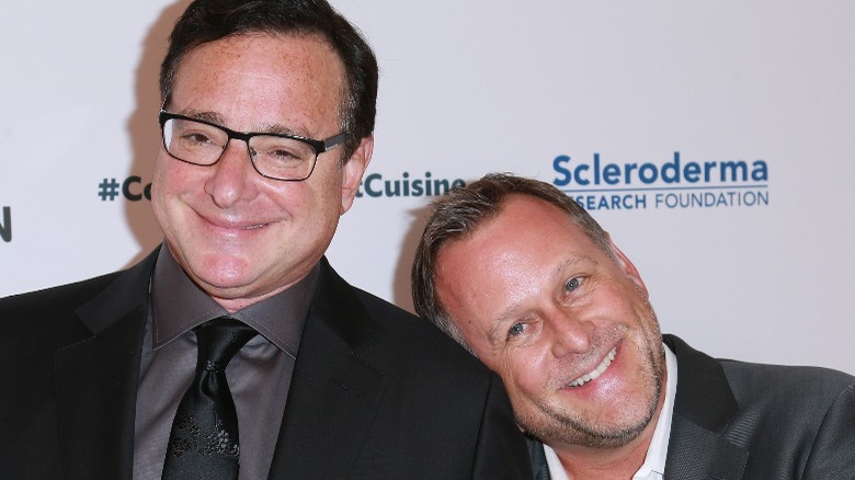 Dave Coulier with his head on Bob Saget