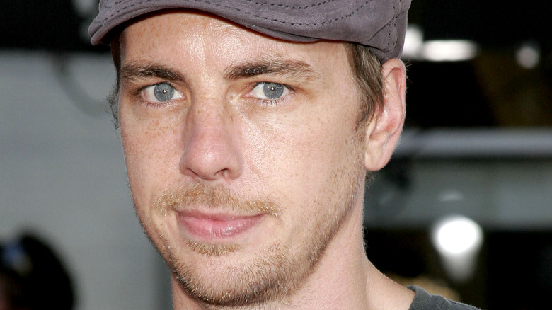 Dax Shepard wearing a newsboy cap, posing