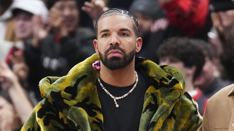 Drake looking sad at a basketball game