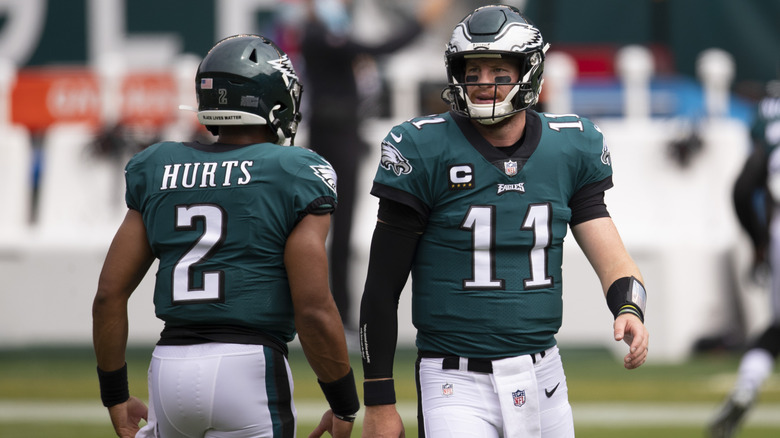 Jalen Hurts and Carson Wentz of the Philadelphia Eagles looking on prior to the game against the Cincinnati Bengals