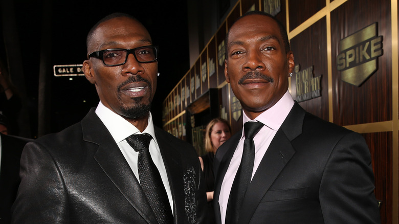 Charlie and Eddie Murphy wearing black ties and formal jackets