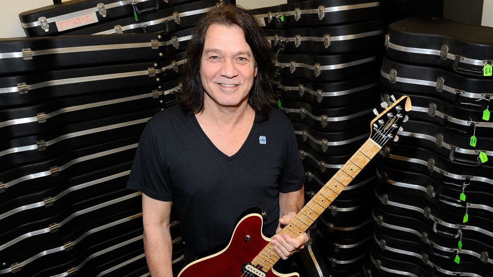 Eddie Van Halen posing with his guitars in 2012