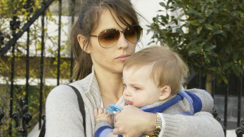 Elizabeth Hurley holding baby Damian 