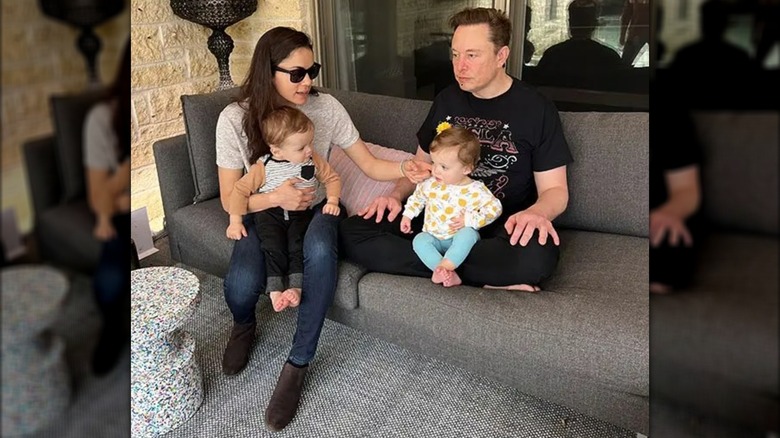 Shivon Zilis and Elon Musk sitting on couch with their twins