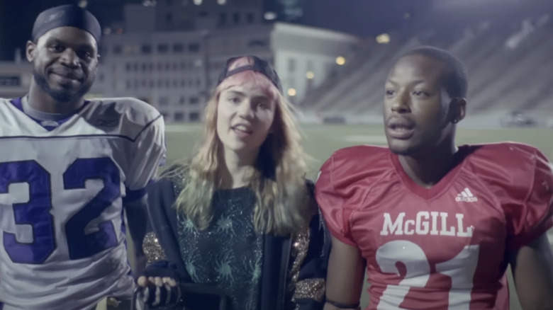 Grimes stands next to football players in Oblivion