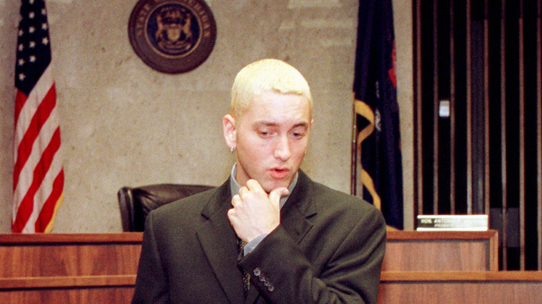 eminem stands in front of american flag in court