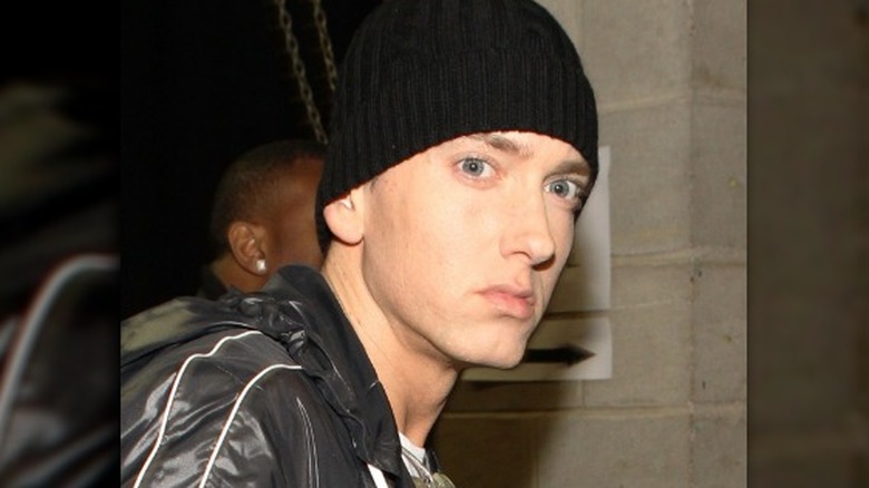 eminem looking serious in black hat