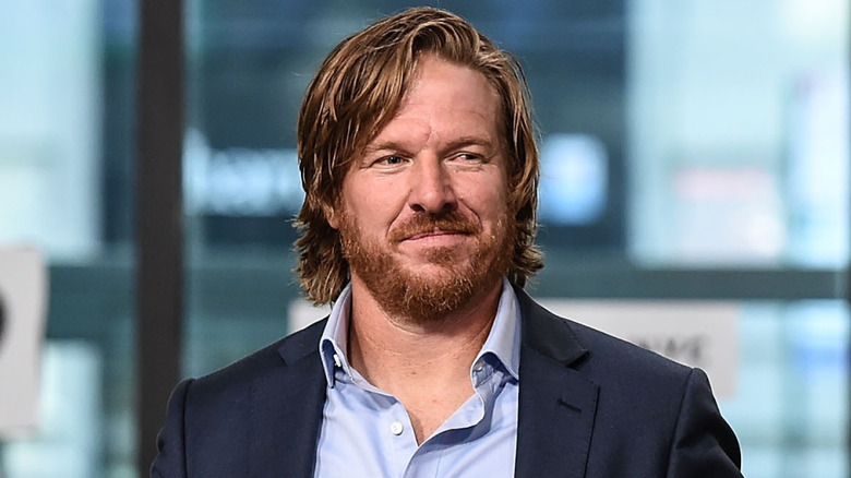 Chip Gaines in a blue jacket and scruffy beard