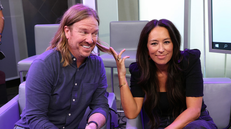 Chip and Joanna Gaines sitting in gray chairs