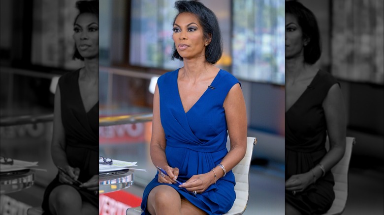 Harris Faulkner with her legs crossed in a blue dress