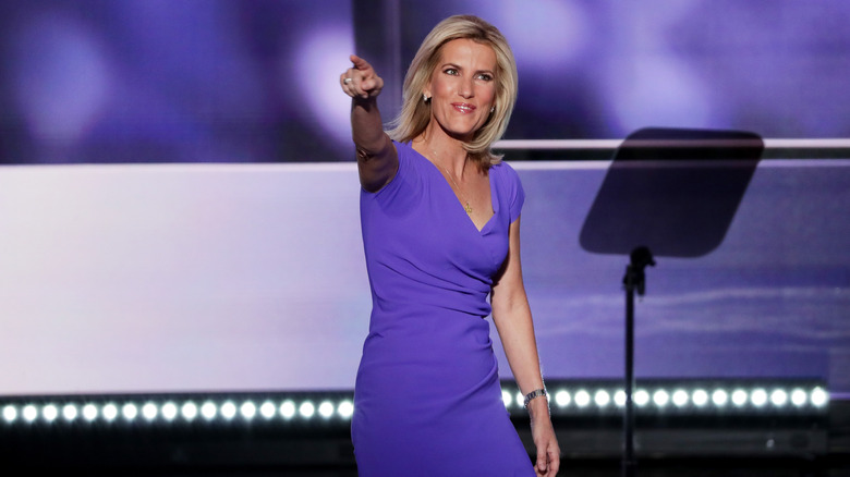 Laura Ingraham gesturing to the crowd as she's walking on stage to speak at the Republican National Convention