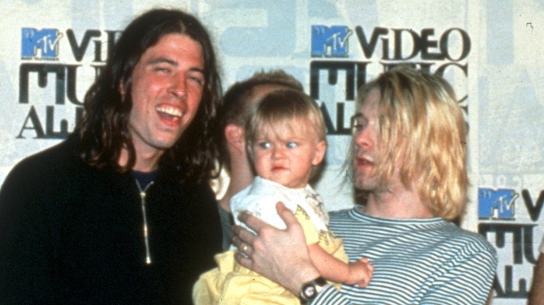 Dave Grohl, baby Frances Bean Cobain, Kurt Cobain, all posing