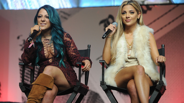 Niki DeMartino and Gabi DeMartino holding microphones