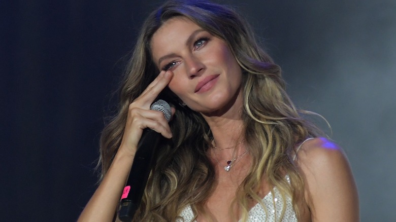 Gisele Bündchen wiping away tears