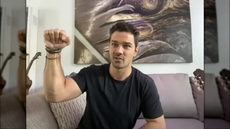 Ryan Paevey holding fist up